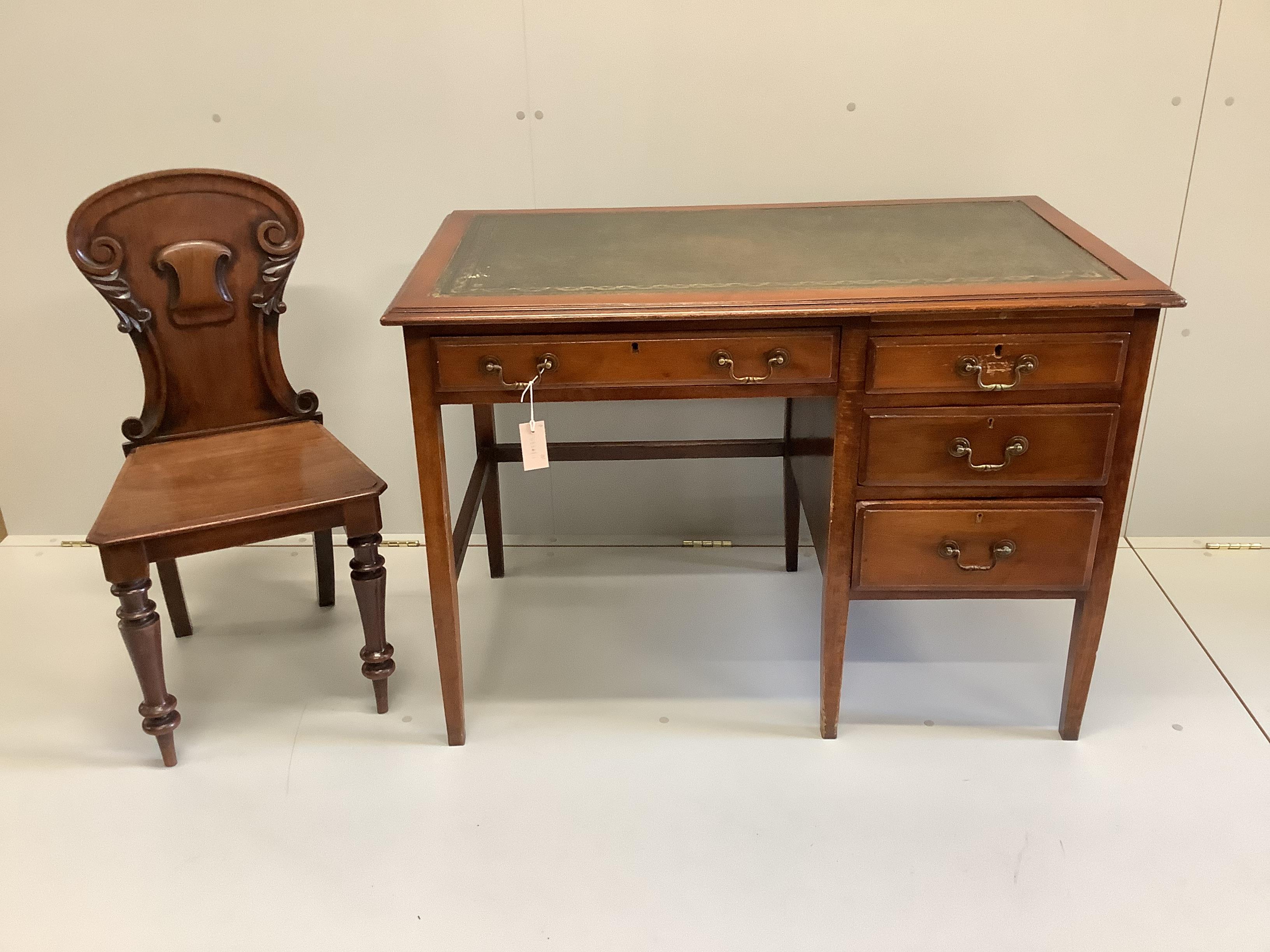 An early 20th century mahogany and beech four drawer kneehole writing desk, width 107cm, depth 60cm, height 75cm, together with a Victorian mahogany hall chair